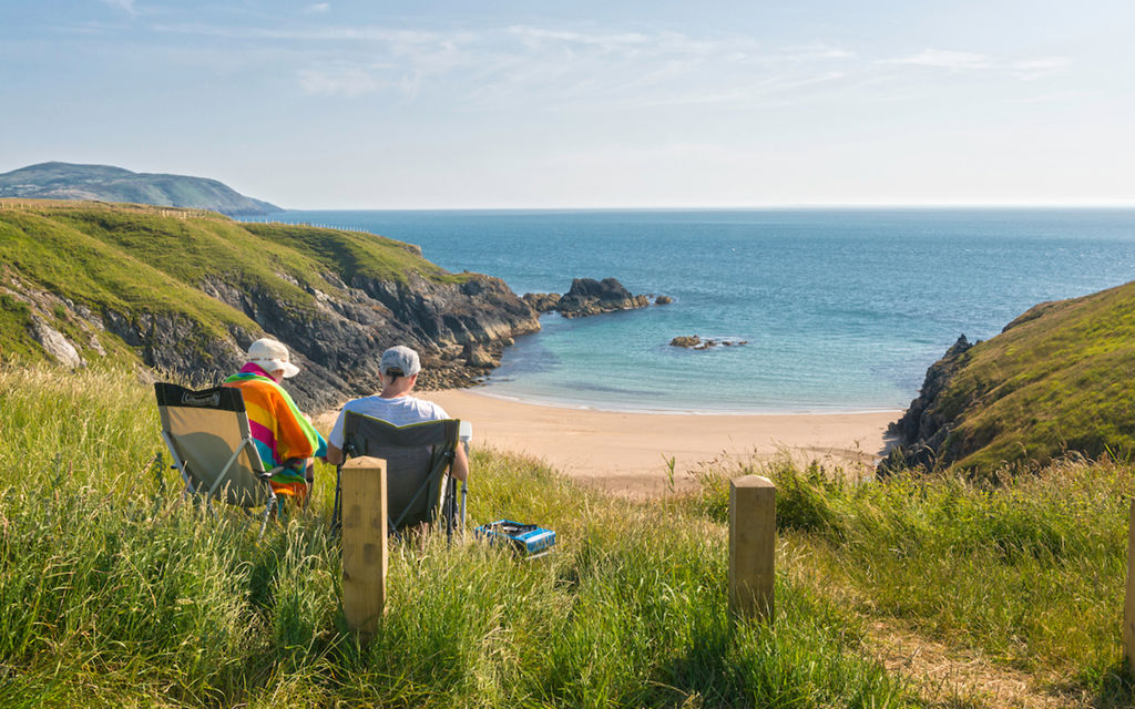 Couple looking over Porth Iago © Visit Wales 2014