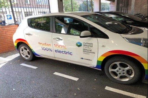 Side view of e-car which had been permanently decorated with the LGBT pride and trans flags