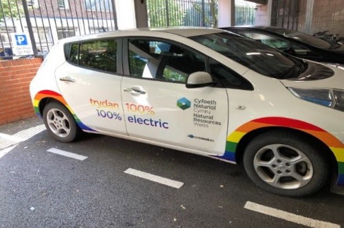 Side view of e-car which had been permanently decorated with the LGBT pride and trans flags