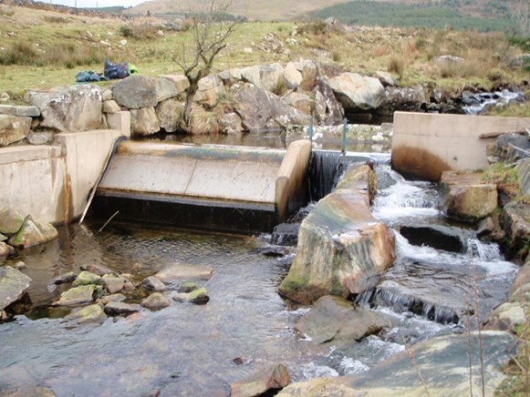 Photograph showing a rock ramp type easement on a micro-hydro scheme that replicates nearby step-pool channel features